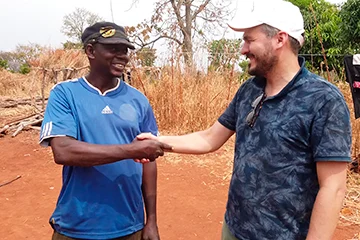 The Managing Director of JOGOO Agriculture with a grower in the field